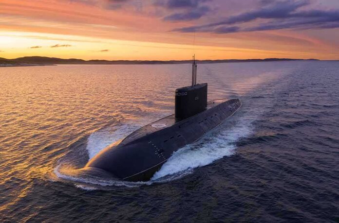Submarine cruising on the surface at sunset