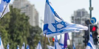 Israeli flags waved at a street demonstration