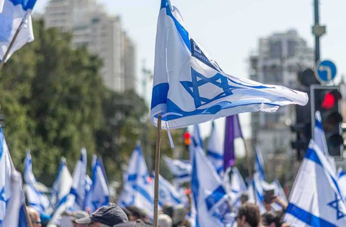 Israeli flags waved at a street demonstration