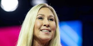 Smiling blonde woman speaking on stage