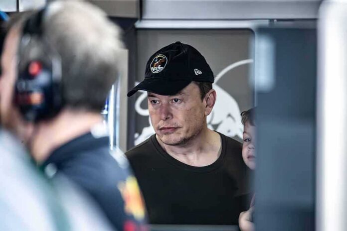 man in black cap looks ahead indoors