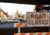 Road closed sign at construction site under overpass