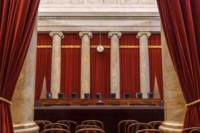 Empty courtroom with marble columns and red curtains