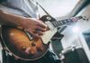 ‘Demonic’ Label Supercharges Worship Anthem Guitarist playing a sunburst electric guitar