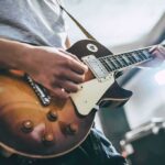 ‘Demonic’ Label Supercharges Worship Anthem Guitarist playing a sunburst electric guitar