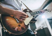 Guitarist playing a sunburst electric guitar