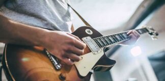 Guitarist playing a sunburst electric guitar