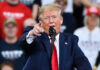 Trump Slaps ‘Fake News’—On-Camera Takedown Rattles CNN Man in suit pointing, speaking at a rally.