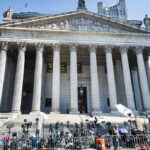 Courtroom Stunner: Verdict Frozen At 11–1 Reporters and photographers gathered outside a neoclassical courthouse