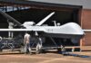 Congress Squabbles, Pentagon Accelerates Drones Military drone being serviced by ground crew outside a hangar