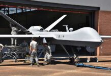 Congress Squabbles, Pentagon Accelerates Drones Military drone being serviced by ground crew outside a hangar