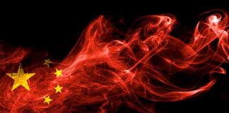 Chinese flag in red smoke on black background