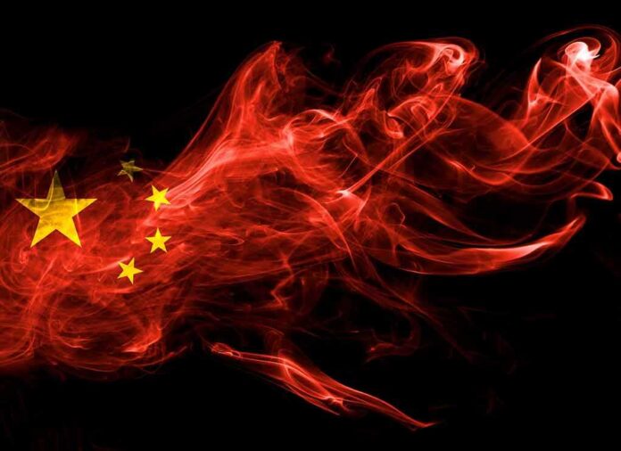 Chinese flag in red smoke on black background