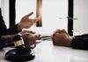 HR Says “Inappropriate” – Mayor’s ‘MILF’ Shock Heads To Court Lawyer consulting client at desk with gavel and scales