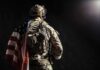 Six Killed — One Sergeant Rushes Toward Fire Soldier in tactical gear with American flag over shoulder
