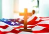 Wooden cross on an American flag