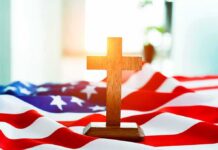 Wooden cross on an American flag