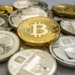 Crypto Stunt: Hunter Trolls MAGA Stack of assorted cryptocurrency coins with a gold bitcoin in the center
