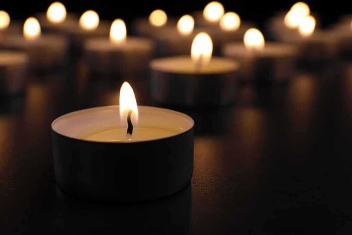 shutterstock_1189298020 Tealight candle burning with soft glow