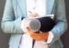 Journalist holding microphones and notepad