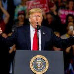 Trump Floods Safe States – Red-State Blitz Masks Bigger Play? Donald Trump speaking at a rally podium with arms raised