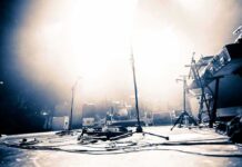 Empty concert stage with instruments and bright lights