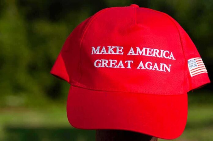 Red baseball cap with political slogan and small U.S. flag patch