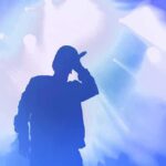 Bipartisan Fury After Chris Brown Tribute Silhouette of a singer holding a microphone on stage