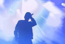 Bipartisan Fury After Chris Brown Tribute Silhouette of a singer holding a microphone on stage
