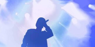 Silhouette of a singer holding a microphone on stage