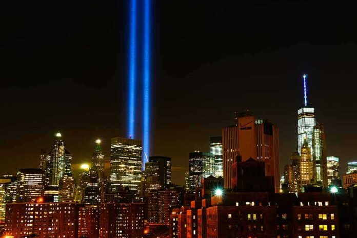 shutterstock_1495332722 New York City skyline at night with twin blue light beams