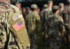Cold War Monster Mauls Iran’s Launch Web Soldier in camouflage with U.S. flag patch at formation