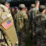 Cold War Monster Mauls Iran’s Launch Web Soldier in camouflage with U.S. flag patch at formation
