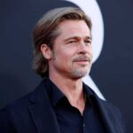 Brad Pitt on a red carpet in a dark suit