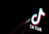 TikTok Hit With $100M – Big Payout, Bigger Limits TikTok logo on a smartphone screen