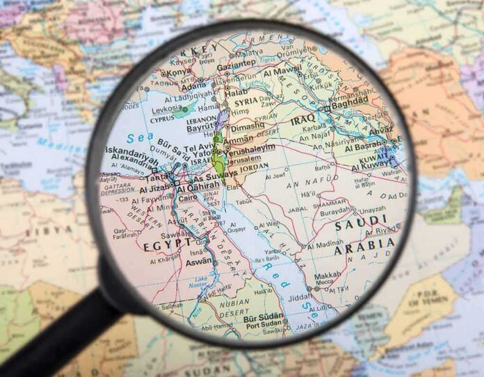 shutterstock_162063665 Magnifying glass over Middle East map