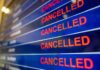 airport departures board showing multiple cancelled flights