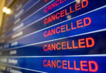 UK Skies Freeze – System Crash Chokes Departures airport departures board showing multiple cancelled flights
