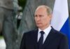 Ballistic Leap Puts Moscow On Notice man in suit standing beside a tricolor flag