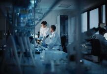 26 Genetic Hits Rattle Fibro Debate Scientists working in a modern laboratory