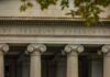 Treasury Surge: Who Gets Crushed First? Neoclassical building facade with Ionic columns and engraved frieze
