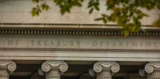 Neoclassical building facade with Ionic columns and engraved frieze
