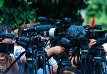 Teachers Topple World Cup Statues, Threaten Escalation TV news cameras crowding together at an outdoor event