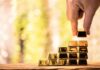Staggering Haul: CIA Gold Hoard Triggers Plea Hand stacking small gold bars into a pyramid