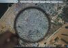 Magnifying glass highlighting Gaza on a digital map