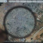 Magnifying glass highlighting Gaza on a digital map