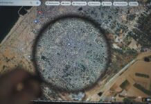 Magnifying glass highlighting Gaza on a digital map