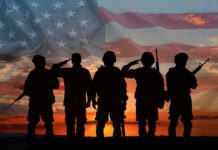 U.S. Vets Linked To Russian Combat School? Soldiers saluting at sunset with American flag overlay