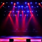 stage with red and blue spotlights shining onto an empty floor