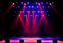 stage with red and blue spotlights shining onto an empty floor